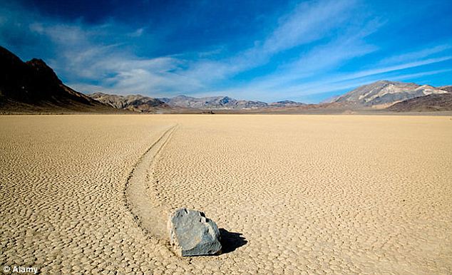 At Racetrack Playa in the Death Valley, California, pictured, heavy rocks appear to move across the floor while no one is looking. Scientists believe the movement may be caused by the ice stuck to the bottom of the stones, which are then moved in the wind. However, no-one has caught the stones in the act