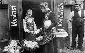 A German woman in the 1923 Weimar Republic purchasing a loaf of bread. This time is almost upon the American people. 