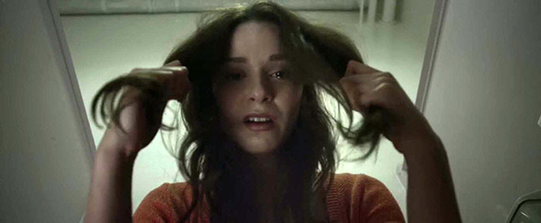 Sarah has a weird fit and pulls out fistfull of hair from her scalp, a disturbing display that appears to soothe her. Sarah's hair will become, throughout the movie, a symbol of her transformation from a "regular girl" to a soulless industry puppet.
